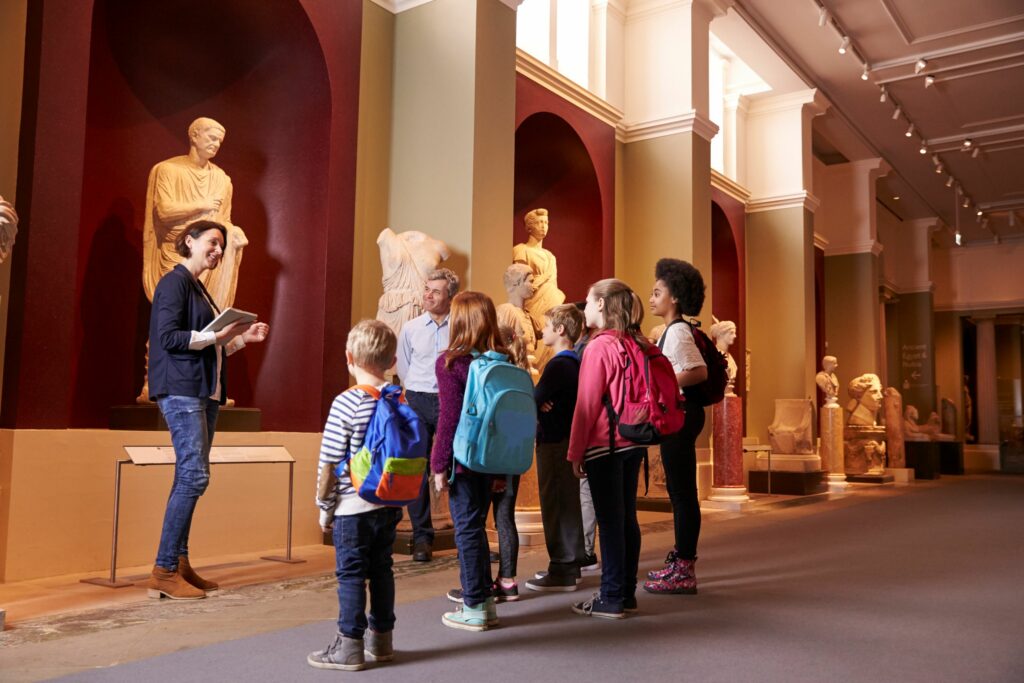 Pupils with a teacher in a museum on a guided tour
