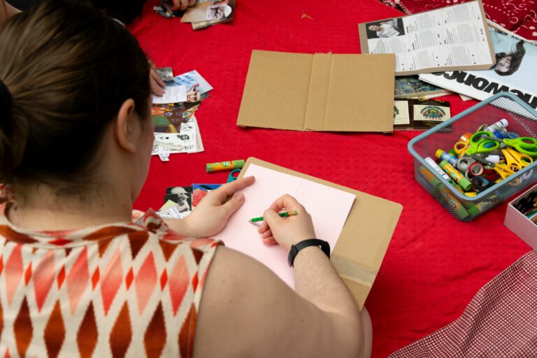 Person drawing on a piece of paper.
