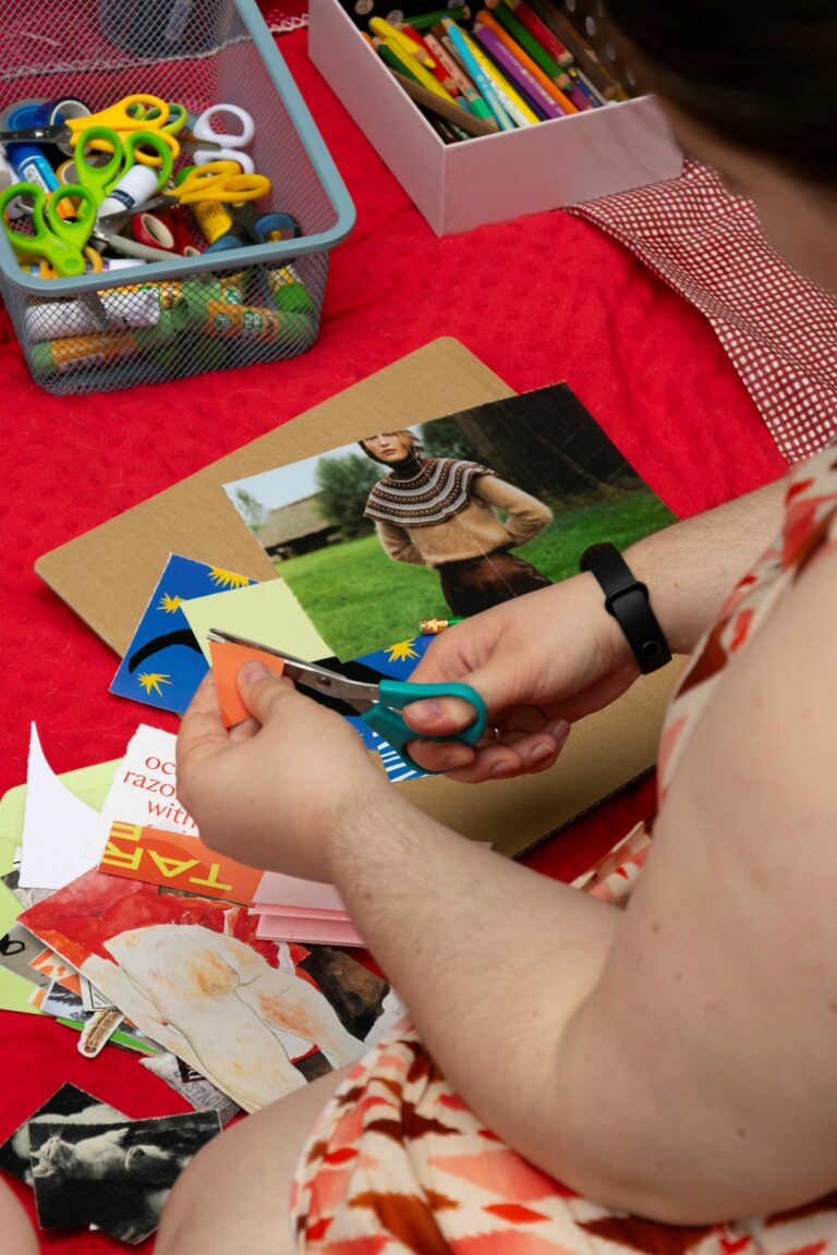Person's hands cutting out with scissors.