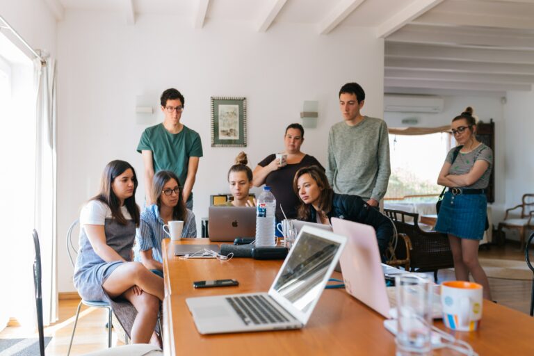 A group of young people at the table in the office